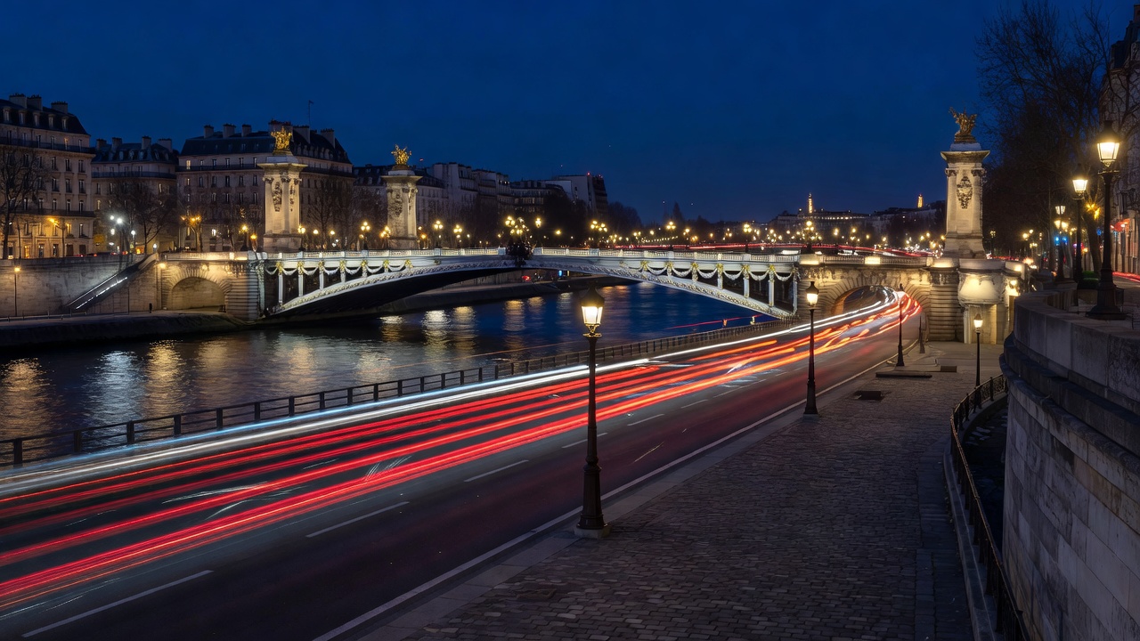 Parisian riverbanks with illuminated bridges and traffic light streaks